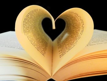 Book with pages turned in so they form a heart