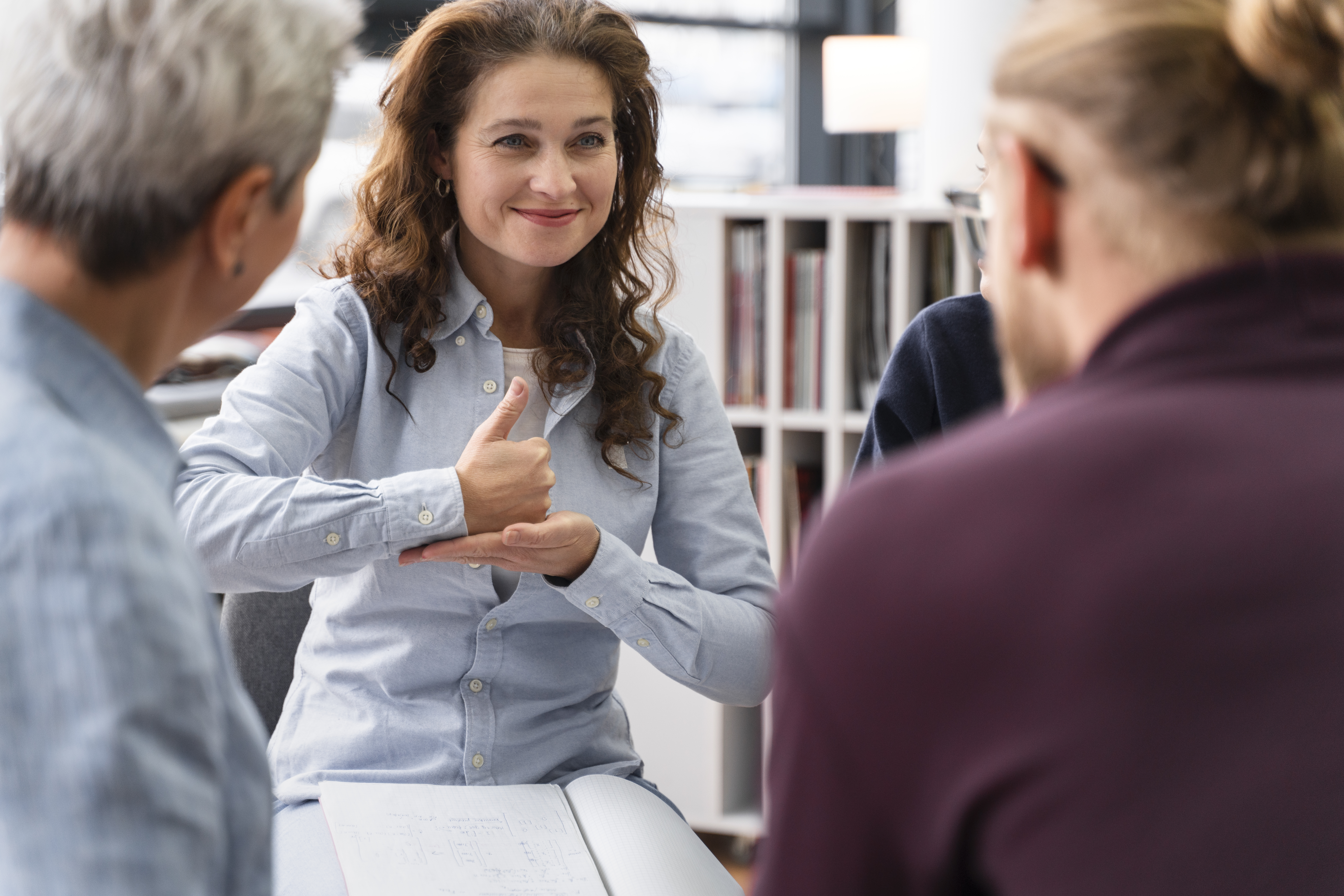 Woman signing in a group of people