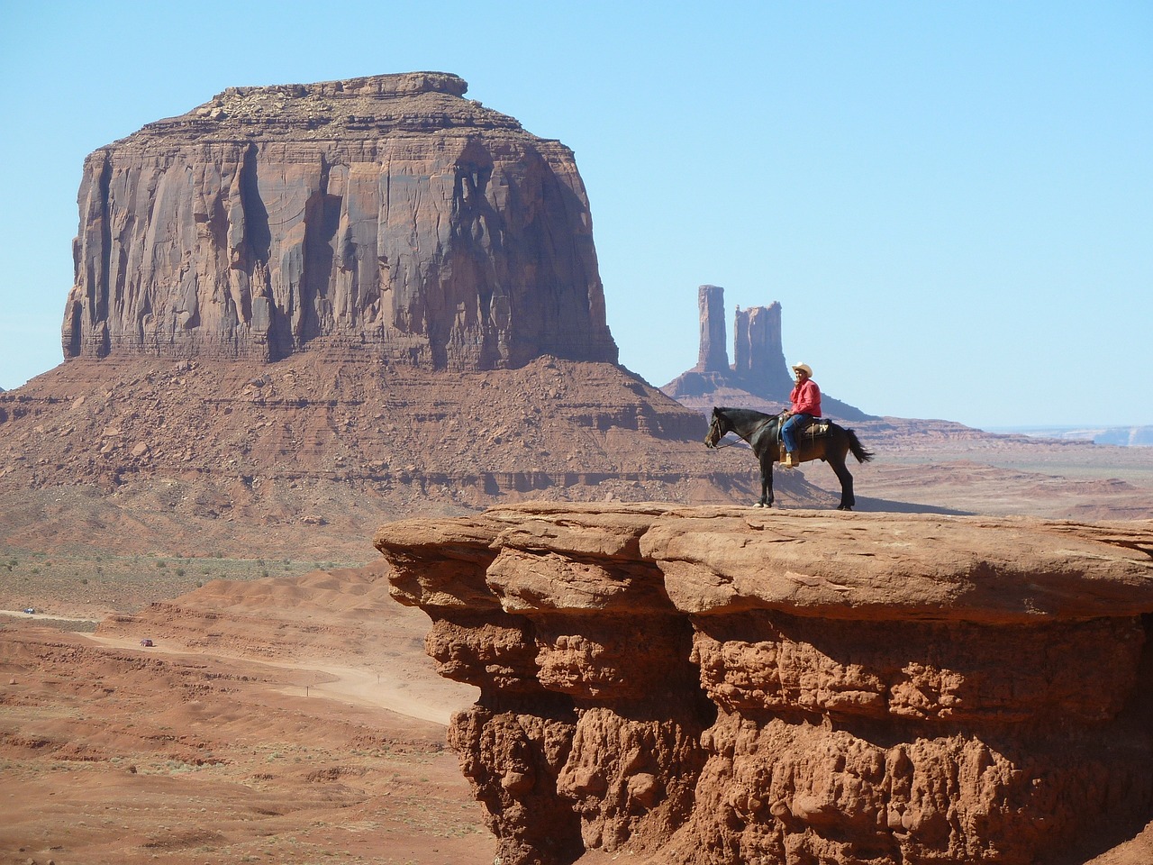 Cowboy on a horse standing on a cliff