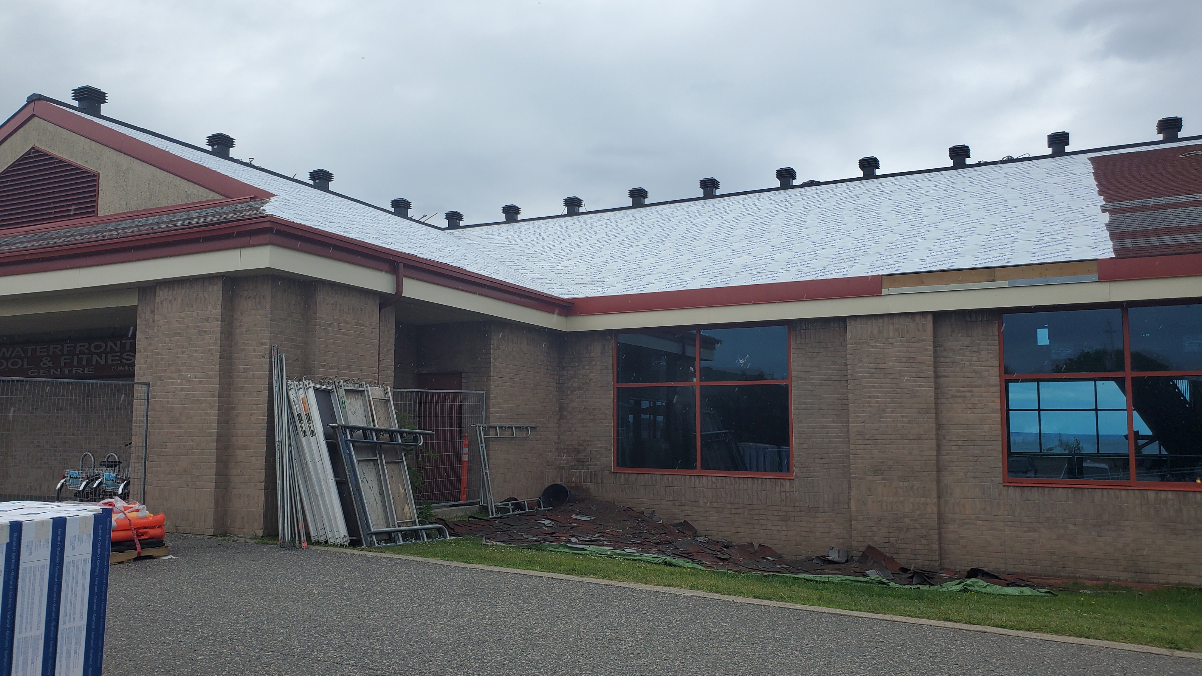 Exterior image of the PFC with part of the shingles removed and roof underlay visible.