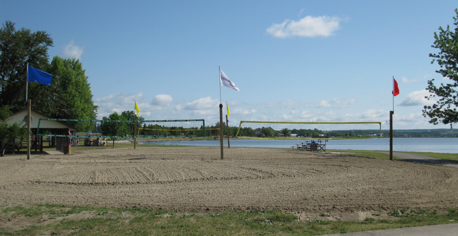 Three empty beach volleyball courts